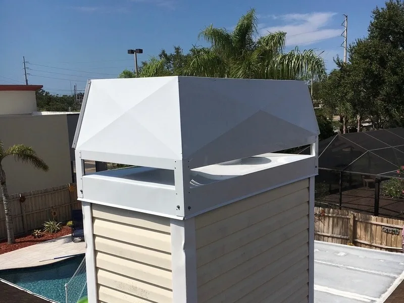 Stainless steel chimney cap installed on white metal flashing real estate inspection