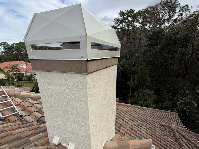 Level 2 chimney inspection on stucco chimney with white metal cap and tile roof
